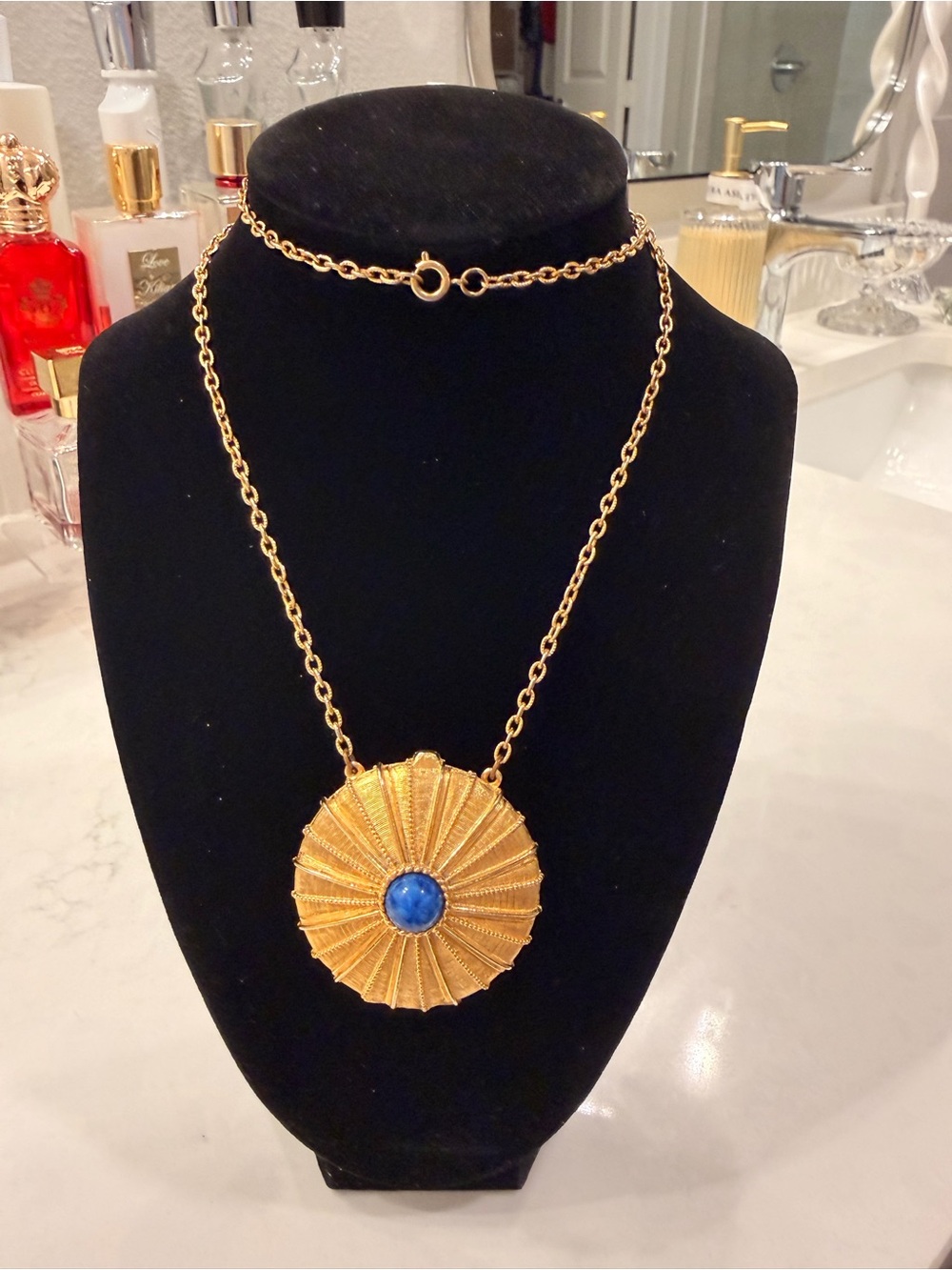 Estée Lauder Gold-Tone Sunburst Pendant Necklace with Blue Cabochon